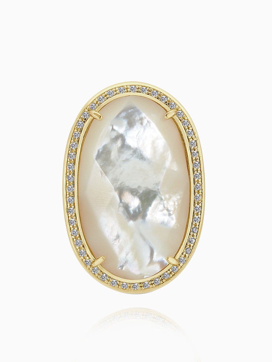 This statement ring features an elegant floral design, crafted from 14K gold-plated 925 sterling silver. The ring is adorned with 5A cubic zirconia and white mother of pearl, creating a striking and sophisticated look. Measuring 1.5 inches (3.8 cm) in length and 1 inch (2.5 cm) in width, this ring by Joy & Rachel is the perfect statement piece to add a touch of luxury to any outfit.