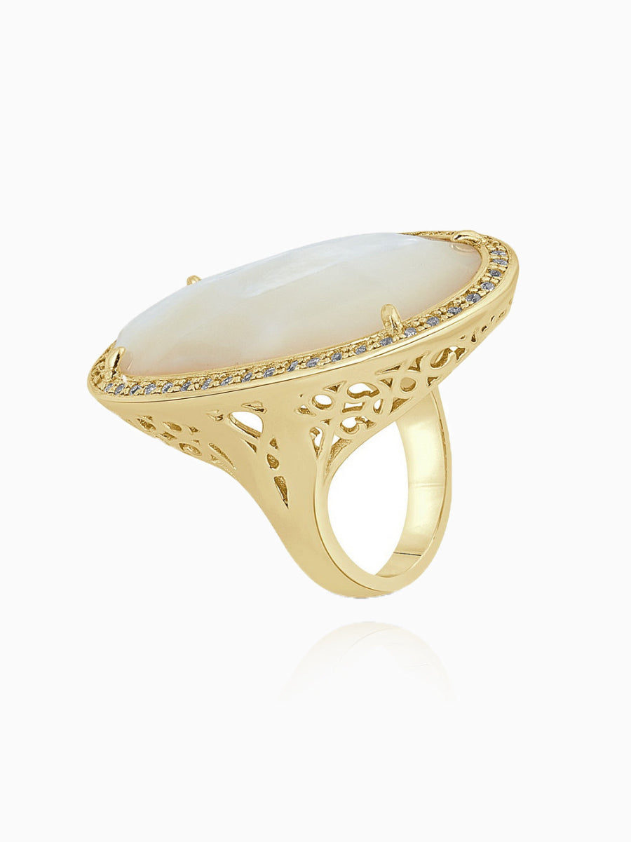 This statement ring features an elegant floral design, crafted from 14K gold-plated 925 sterling silver. The ring is adorned with 5A cubic zirconia and white mother of pearl, creating a striking and sophisticated look. Measuring 1.5 inches (3.8 cm) in length and 1 inch (2.5 cm) in width, this ring by Joy & Rachel is the perfect statement piece to add a touch of luxury to any outfit.
