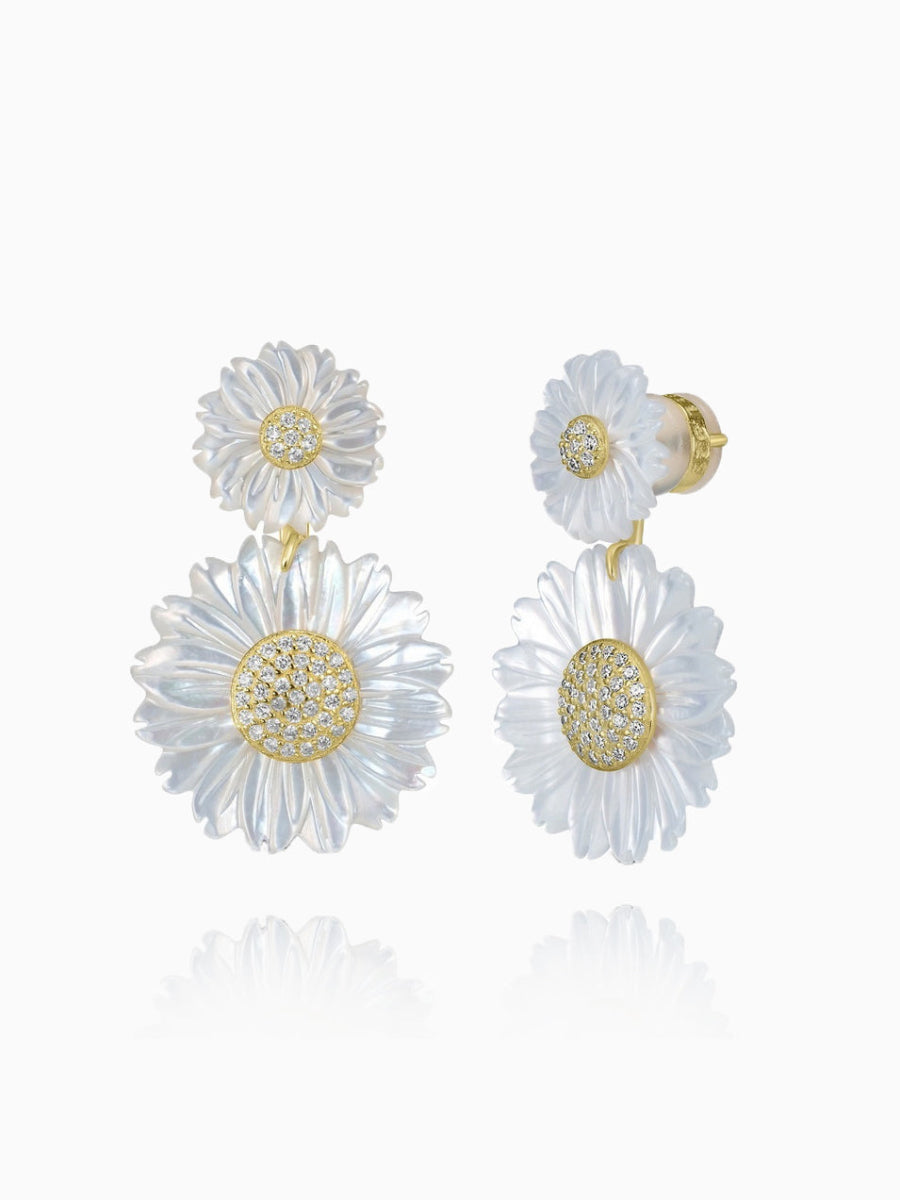 These stunning double daisy flower earrings are crafted from 14K gold-plated sterling silver and feature 5A cubic zirconia stones along with white mother of pearl. The earrings are designed with a post back for secure wear. Each earring measures 1.3 inches in length and 0.8 inches in width, and the piece is from the Joy & Rachel brand.